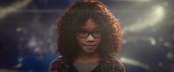 Movie still from “A Wrinkle in Time” (2018), directed by Ava DuVernay – A young girl wearing glasses and a plaid shirt; Close Up shot, Over the shoulder angle