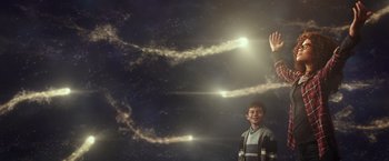 Movie still from “A Wrinkle in Time” (2018), directed by Ava DuVernay – A young boy standing in front of a sky filled with stars; Medium shot, Over the shoulder angle