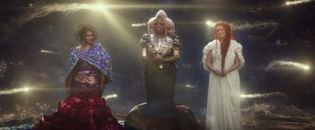 Movie still from “A Wrinkle in Time” (2018), directed by Ava DuVernay – A group of people standing next to each other in front of lights; Wide shot, Low angle