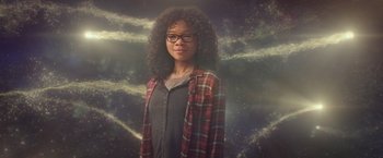 Movie still from “A Wrinkle in Time” (2018), directed by Ava DuVernay – A woman with curly black hair wearing a plaid shirt; Medium shot, Low angle