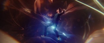 A young man is dancing in the dark