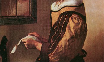 Movie still from “A Zed & Two Noughts” (1985), directed by Peter Greenaway – A person playing a game with a remote controller; Close Up shot, Over the shoulder angle