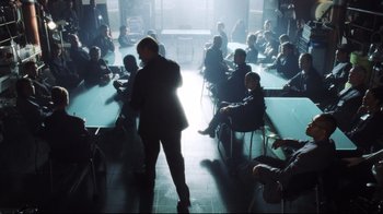 Movie still from “A.I. Artificial Intelligence” (2001), directed by Steven Spielberg – A group of people sitting around a table; Wide shot, Over the shoulder angle