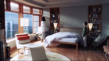 Movie still from “A.I. Artificial Intelligence” (2001), directed by Steven Spielberg – Two people standing in a bedroom next to a bed; Wide shot, High angle