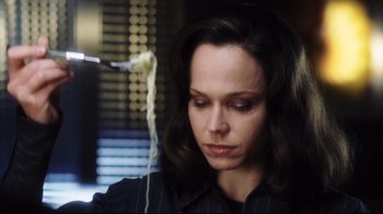 Movie still from “A.I. Artificial Intelligence” (2001), directed by Steven Spielberg – A person sitting down with a pasta in front of her face; Close Up shot, High angle