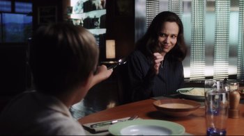 Movie still from “A.I. Artificial Intelligence” (2001), directed by Steven Spielberg – A woman sitting at a table with a bowl of soup in front of a boy; Medium shot, Over the shoulder angle