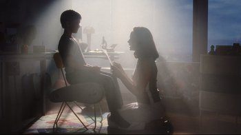Movie still from “A.I. Artificial Intelligence” (2001), directed by Steven Spielberg – A woman sitting next to a man in a chair; Medium shot, Low angle