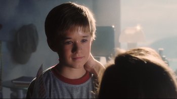 Movie still from “A.I. Artificial Intelligence” (2001), directed by Steven Spielberg – A young boy is looking into the camera; Close Up shot, Over the shoulder angle