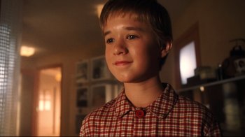 Movie still from “A.I. Artificial Intelligence” (2001), directed by Steven Spielberg – A young boy in a red and white checkered shirt; Close Up shot, Low angle