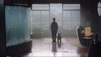 Movie still from “A.I. Artificial Intelligence” (2001), directed by Steven Spielberg – A person standing in a room with a teddy bear; Wide shot, Low angle