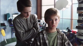 Movie still from “A.I. Artificial Intelligence” (2001), directed by Steven Spielberg – A boy and a girl looking at each other in a room; Close Up shot, Low angle