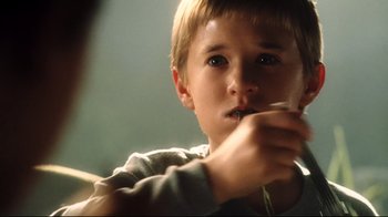 Movie still from “A.I. Artificial Intelligence” (2001), directed by Steven Spielberg – A young boy is holding a toothbrush in his mouth; Close Up shot, Over the shoulder angle