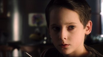 Movie still from “A.I. Artificial Intelligence” (2001), directed by Steven Spielberg – A young person with brown eyes; Close Up shot, Over the shoulder angle