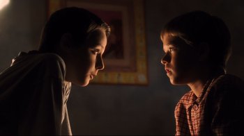 Movie still from “A.I. Artificial Intelligence” (2001), directed by Steven Spielberg – Two young boys face each other in the dark; Close Up shot, Low angle