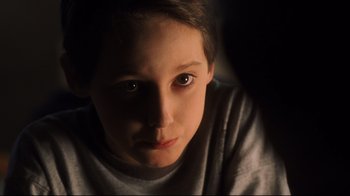 Movie still from “A.I. Artificial Intelligence” (2001), directed by Steven Spielberg – A young boy is staring at the camera; Close Up shot, High angle