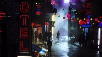 Movie still from “A.I. Artificial Intelligence” (2001), directed by Steven Spielberg – People walking down a street at night in the rain; Extreme Wide shot, High angle