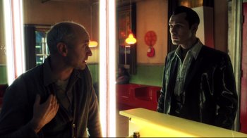 Movie still from “A.I. Artificial Intelligence” (2001), directed by Steven Spielberg – A man is looking at himself in the mirror; Medium shot, Over the shoulder angle