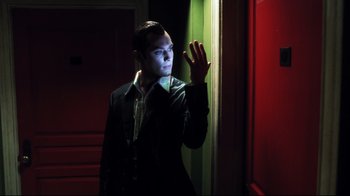 Movie still from “A.I. Artificial Intelligence” (2001), directed by Steven Spielberg – A man standing next to a green door; Medium shot, Low angle