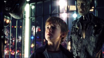 Movie still from “A.I. Artificial Intelligence” (2001), directed by Steven Spielberg – A young boy standing in front of a statue; Close Up shot, Over the shoulder angle