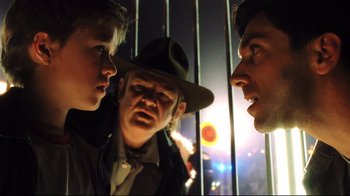 Movie still from “A.I. Artificial Intelligence” (2001), directed by Steven Spielberg – Two men and a boy are talking to each other; Close Up shot, Over the shoulder angle