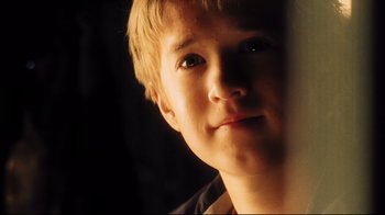 Movie still from “A.I. Artificial Intelligence” (2001), directed by Steven Spielberg – A young man's face in the dark; Close Up shot, Low angle