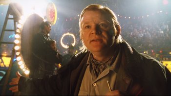 Movie still from “A.I. Artificial Intelligence” (2001), directed by Steven Spielberg – A man in a crowd of people in front of a crowd; Close Up shot, Low angle