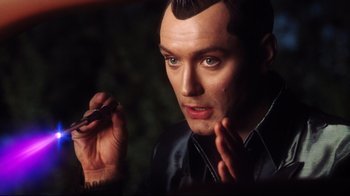 Movie still from “A.I. Artificial Intelligence” (2001), directed by Steven Spielberg – A man is holding a cell phone in his hand; Close Up shot, High angle