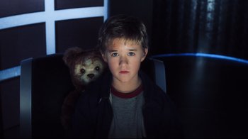 Movie still from “A.I. Artificial Intelligence” (2001), directed by Steven Spielberg – A young boy with a teddy bear in a dark room; Close Up shot, Low angle