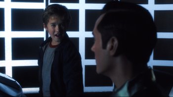 A young boy and his father in a dark room