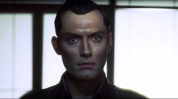 Movie still from “A.I. Artificial Intelligence” (2001), directed by Steven Spielberg – A person wearing a suit and tie; Close Up shot, Low angle