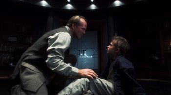 Movie still from “A.I. Artificial Intelligence” (2001), directed by Steven Spielberg – A man and a boy sitting on the floor talking to each other; Medium shot, Over the shoulder angle