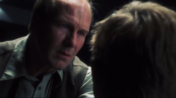 Movie still from “A.I. Artificial Intelligence” (2001), directed by Steven Spielberg – An older man in a suit and tie talking to a younger man; Close Up shot, Over the shoulder angle