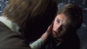 Movie still from “A.I. Artificial Intelligence” (2001), directed by Steven Spielberg – A young boy looking at his reflection in a mirror; Close Up shot, Over the shoulder angle