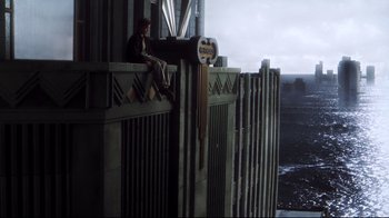 Movie still from “A.I. Artificial Intelligence” (2001), directed by Steven Spielberg – A man sitting on the ledge of a skyscraper; Extreme Wide shot, High angle