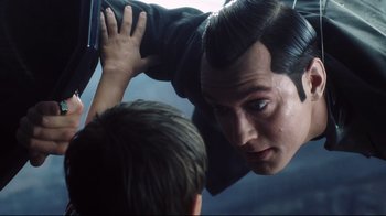 Movie still from “A.I. Artificial Intelligence” (2001), directed by Steven Spielberg – A man with long hair is looking into a mirror while another man looks at him; Close Up shot, Over the shoulder angle