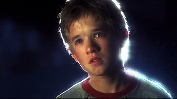 Movie still from “A.I. Artificial Intelligence” (2001), directed by Steven Spielberg – A young boy is looking into the camera; Close Up shot, Low angle