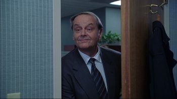 Movie still from “About Schmidt” (2002), directed by Alexander Payne – A man in a suit and tie looking at the camera; Medium shot, Low angle