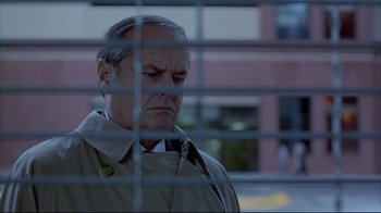 Movie still from “About Schmidt” (2002), directed by Alexander Payne – An older man wearing a trench coat looking out a window; Close Up shot, Low angle