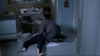 Movie still from “About Schmidt” (2002), directed by Alexander Payne – A man helping another man who is laying on the ground; Medium shot, High angle