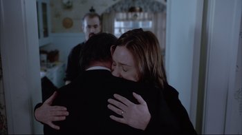 Movie still from “About Schmidt” (2002), directed by Alexander Payne – Two people hugging each other in front of a mirror; Medium shot, Over the shoulder angle