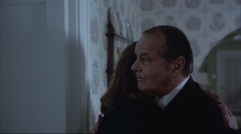 Movie still from “About Schmidt” (2002), directed by Alexander Payne – A man and a woman are hugging in a room; Close Up shot, Over the shoulder angle