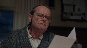 Movie still from “About Schmidt” (2002), directed by Alexander Payne – An older man wearing glasses looking at a paper; Close Up shot, Low angle