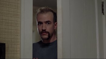 Movie still from “About Schmidt” (2002), directed by Alexander Payne – A person with a beard looking in a mirror; Close Up shot, Low angle