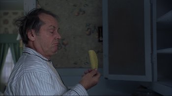 Movie still from “About Schmidt” (2002), directed by Alexander Payne – A man holding a banana in his hand; Close Up shot, High angle