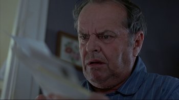Movie still from “About Schmidt” (2002), directed by Alexander Payne – An older man is looking at a newspaper; Close Up shot, Low angle
