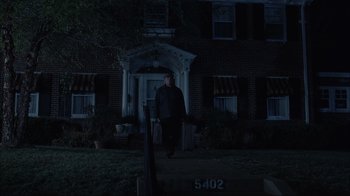 Movie still from “About Schmidt” (2002), directed by Alexander Payne – A man walking in front of a house at night; Wide shot, Low angle