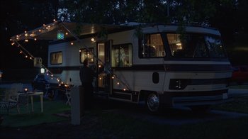 Movie still from “About Schmidt” (2002), directed by Alexander Payne – A man standing in front of an rv at night; Wide shot, High angle