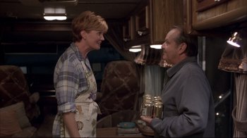 Movie still from “About Schmidt” (2002), directed by Alexander Payne – A man and a woman are talking in a kitchen; Medium shot, Low angle