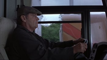 Movie still from “About Schmidt” (2002), directed by Alexander Payne – A man sitting in a car with his hand on the steering wheel of a bus; Close Up shot, Low angle