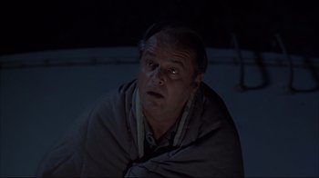 Movie still from “About Schmidt” (2002), directed by Alexander Payne – A man with a blanket wrapped around his head; Medium shot, Low angle